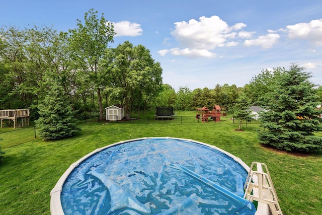 227 Maple Ln, Jordan, MN 55352 - view of swimming pool with a trampoline and a playground