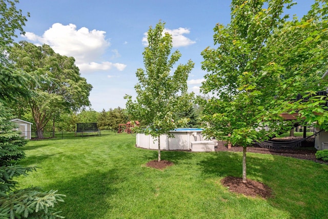 227 Maple Ln, Jordan, MN 55352 - view of yard with a trampoline and an outdoor pool
