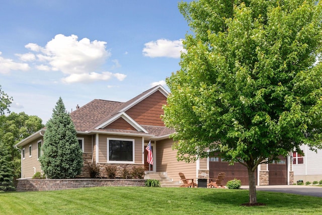 227 Maple Ln, Jordan, MN 55352 - view of front of home with stone siding, driveway, and a front lawn