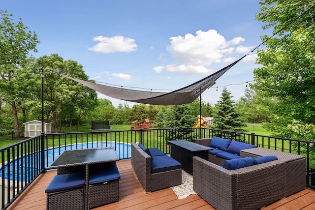 227 Maple Ln, Jordan, MN 55352 - wooden deck with a playground, an outdoor living space, a lawn, outdoor dining area, and a trampoline