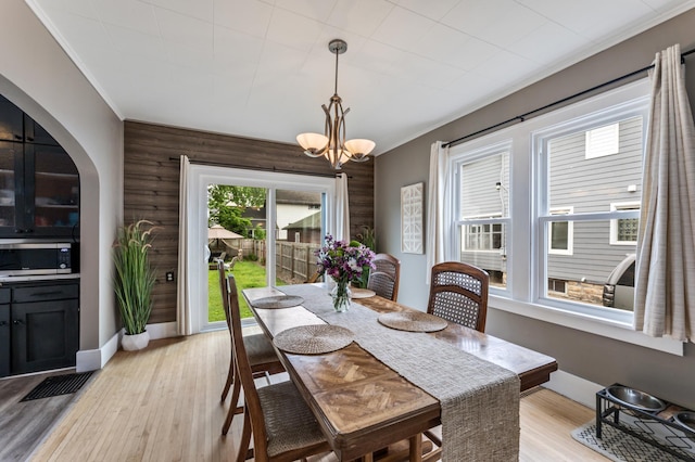 473 4th St, Winona, MN 55987 - dining room with a chandelier, light wood finished floors, and arched walkways