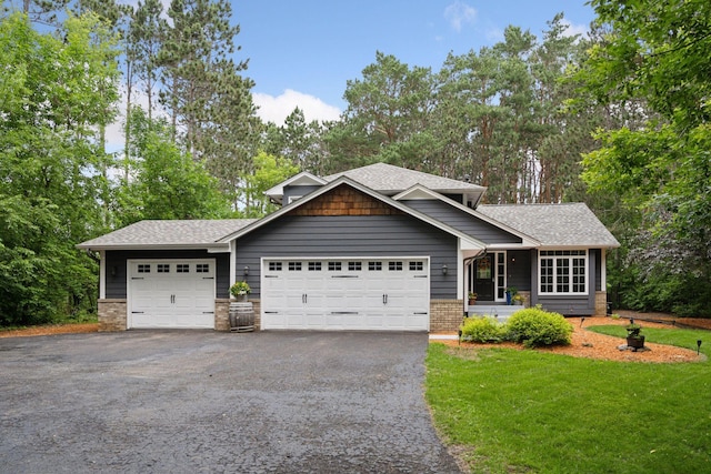 13171 Island View Dr NW, Elk River, MN 55330 - view of front of home with driveway, a front yard, a garage, and view of wooded area
