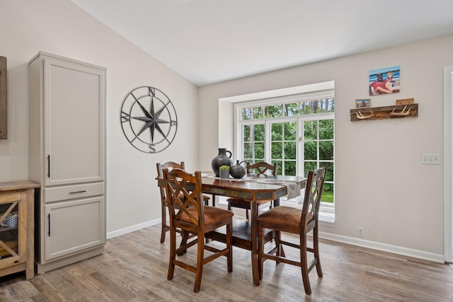 13171 Island View Dr NW, Elk River, MN 55330 - dining space with light wood-style flooring and vaulted ceiling
