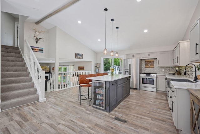 13171 Island View Dr NW, Elk River, MN 55330 - kitchen featuring appliances with stainless steel finishes, gray cabinets, light countertops, wine cooler, and beamed ceiling