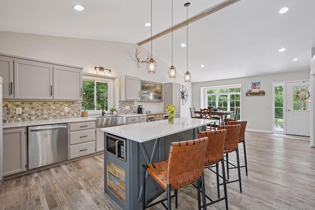 13171 Island View Dr NW, Elk River, MN 55330 - kitchen with stainless steel appliances, light countertops, tasteful backsplash, light wood-style floors, and recessed lighting