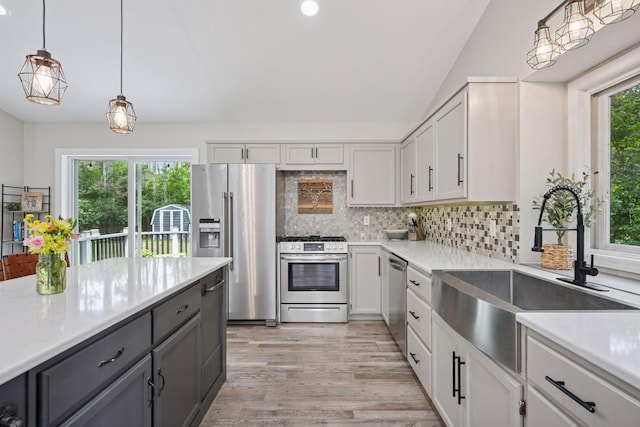 13171 Island View Dr NW, Elk River, MN 55330 - kitchen with appliances with stainless steel finishes, light countertops, decorative backsplash, lofted ceiling, and recessed lighting