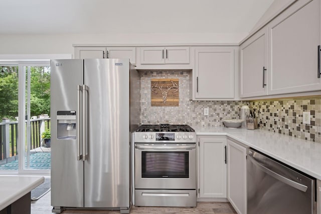 13171 Island View Dr NW, Elk River, MN 55330 - kitchen featuring stainless steel appliances, light countertops, backsplash, and white cabinets