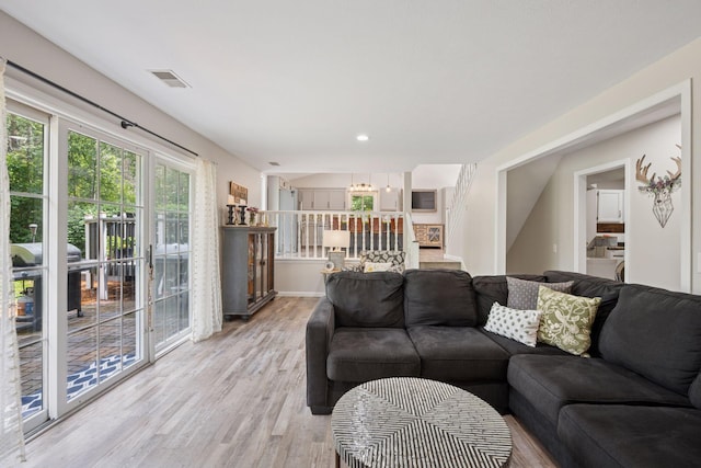 13171 Island View Dr NW, Elk River, MN 55330 - living room with light wood-style floors, stairway, and recessed lighting