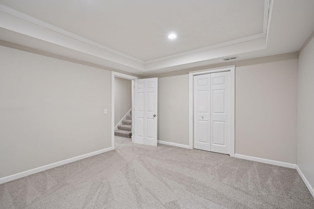 13171 Island View Dr NW, Elk River, MN 55330 - unfurnished bedroom featuring ornamental molding, a tray ceiling, carpet floors, a closet, and recessed lighting