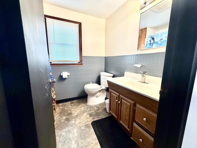 1402 Kirkwood Ave, Albert Lea, MN 56007 - bathroom featuring toilet, vanity, tile walls, wainscoting, and a shower with shower curtain