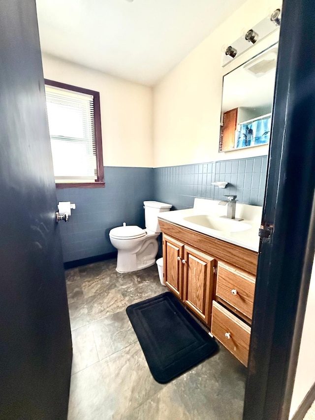 1402 Kirkwood Ave, Albert Lea, MN 56007 - bathroom with tile walls, vanity, toilet, and wainscoting