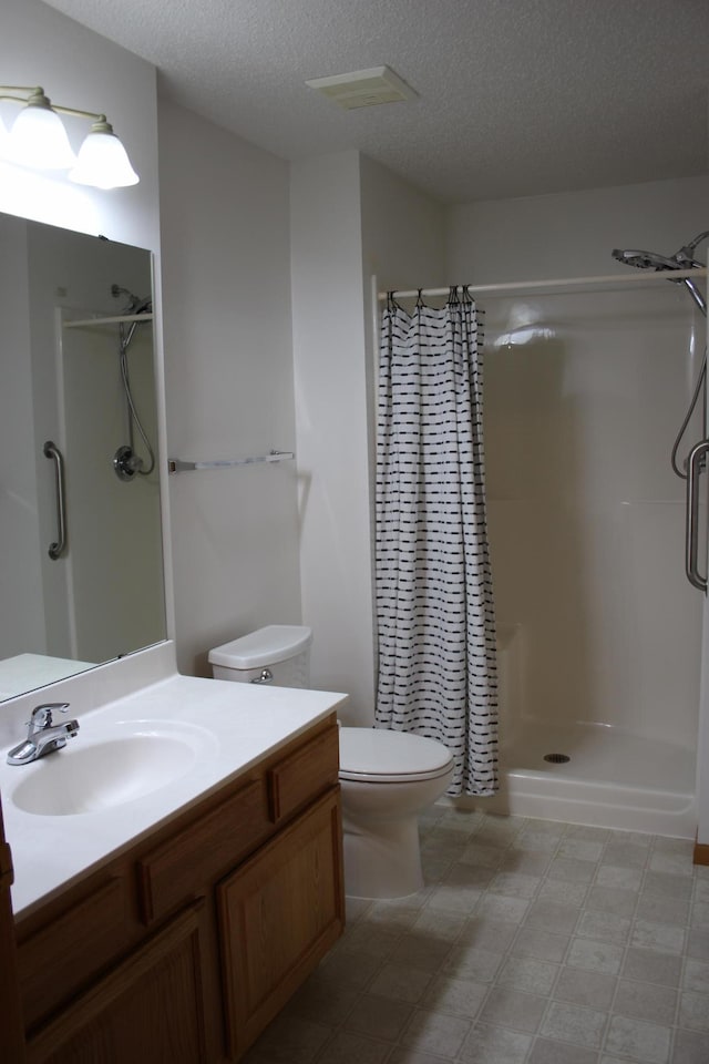 7642 Palisades Ave NE, Otsego, MN 55330 - full bath with vanity, a shower stall, toilet, tile patterned floors, and a textured ceiling