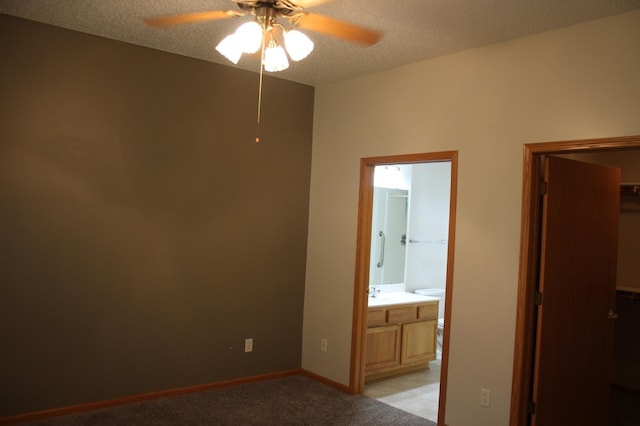 7642 Palisades Ave NE, Otsego, MN 55330 - unfurnished bedroom with ensuite bathroom, light colored carpet, a textured ceiling, ceiling fan, and a sink