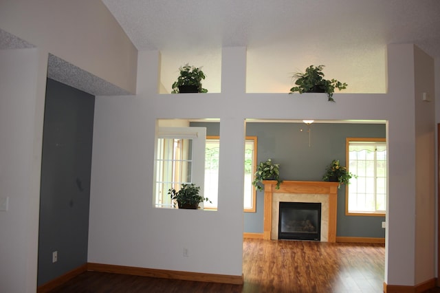 7642 Palisades Ave NE, Otsego, MN 55330 - living area featuring wood finished floors, a glass covered fireplace, and baseboards