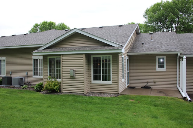7642 Palisades Ave NE, Otsego, MN 55330 - back of property with a shingled roof, a lawn, a patio area, and cooling unit