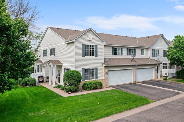 13055 Europa Trail Way N Unit A, Hugo, MN 55038 - townhome / multi-family property featuring a shingled roof, driveway, an attached garage, and a front lawn