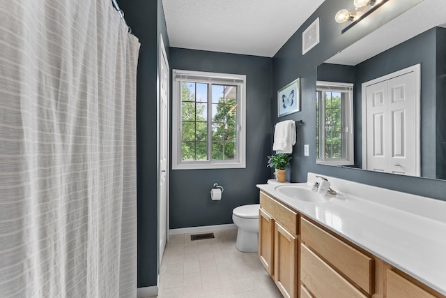 13055 Europa Trail Way N Unit A, Hugo, MN 55038 - bathroom with toilet, vanity, baseboards, and tile patterned flooring
