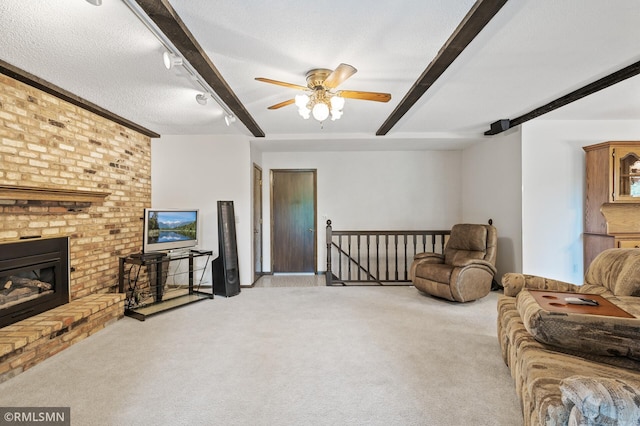 10425 Quaker Ln N, Maple Grove, MN 55369 - living area with beam ceiling, light carpet, ceiling fan, a fireplace, and a textured ceiling