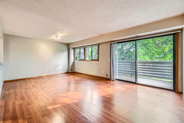 8932 Neill Lake Rd Unit 112B, Eden Prairie, MN 55347 - spare room with a textured ceiling, light wood finished floors, and baseboards