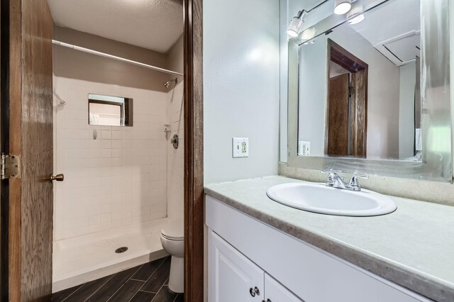 8932 Neill Lake Rd Unit 112B, Eden Prairie, MN 55347 - bathroom featuring toilet, vanity, a shower stall, and wood finished floors
