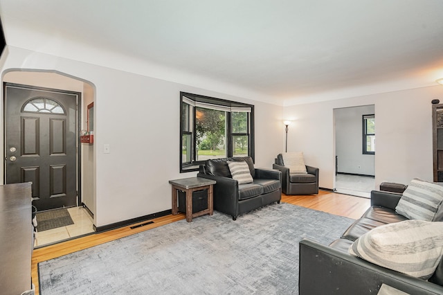 4101 Welcome Ave N, Robbinsdale, MN 55422 - living room with light wood-style floors and arched walkways
