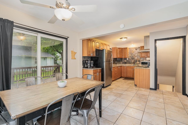 4101 Welcome Ave N, Robbinsdale, MN 55422 - kitchen featuring appliances with stainless steel finishes, backsplash, light tile patterned flooring, ceiling fan, and brown cabinets