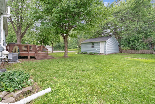 4101 Welcome Ave N, Robbinsdale, MN 55422 - view of green lawn with a deck, view of wooded area, and a storage shed
