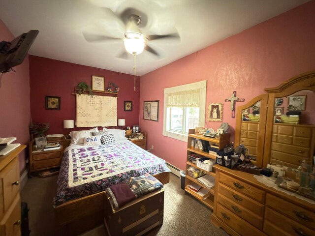 107 3rd Ave, Bellingham, MN 56212 - bedroom featuring a baseboard heating unit, dark carpet, and a ceiling fan