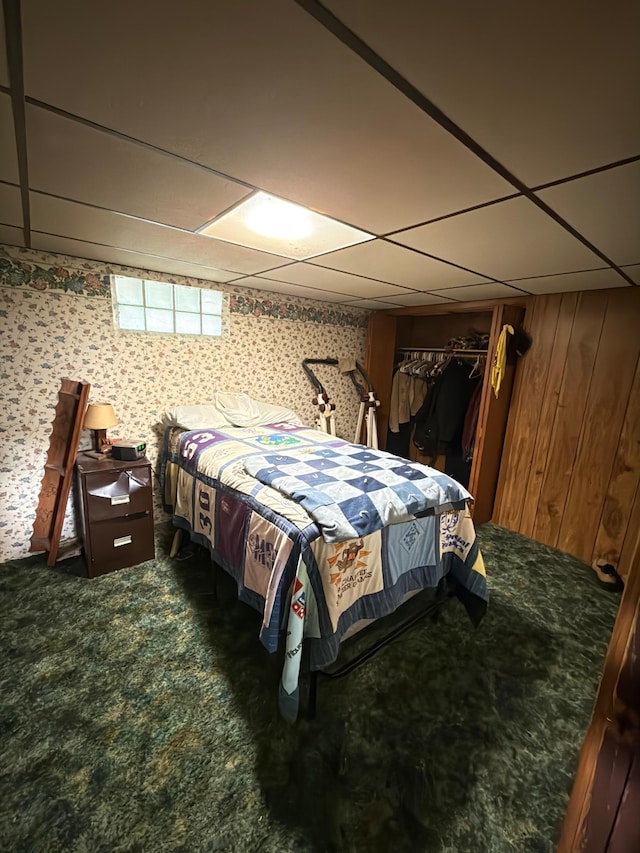 107 3rd Ave, Bellingham, MN 56212 - bedroom with a paneled ceiling, carpet floors, and wood walls
