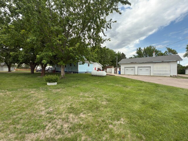 107 3rd Ave, Bellingham, MN 56212 - view of grassy yard with a garage and an outdoor structure