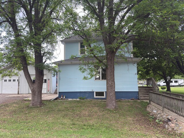 107 3rd Ave, Bellingham, MN 56212 - view of front of property with a front lawn and a garage