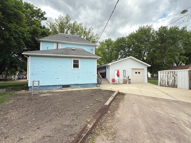 107 3rd Ave, Bellingham, MN 56212 - rear view of property featuring an outbuilding, a garage, and roof with shingles