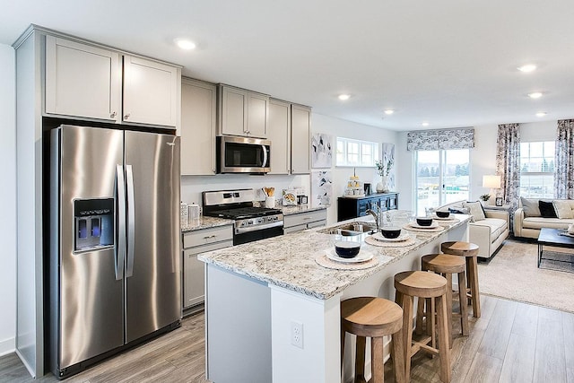 12549 Guadalcanal Cir NE Unit E, Blaine, MN 55449 - kitchen with appliances with stainless steel finishes, gray cabinets, a sink, light wood finished floors, and recessed lighting