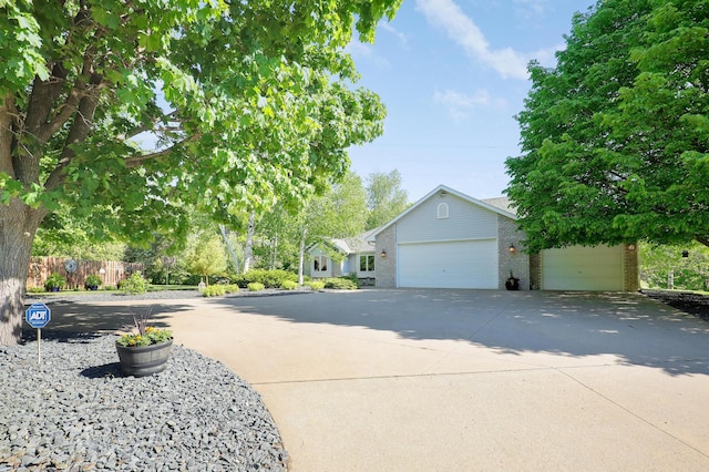 2301 170th Ln NW, Andover, MN 55304 - view of front of home featuring an attached garage, concrete driveway, and brick siding