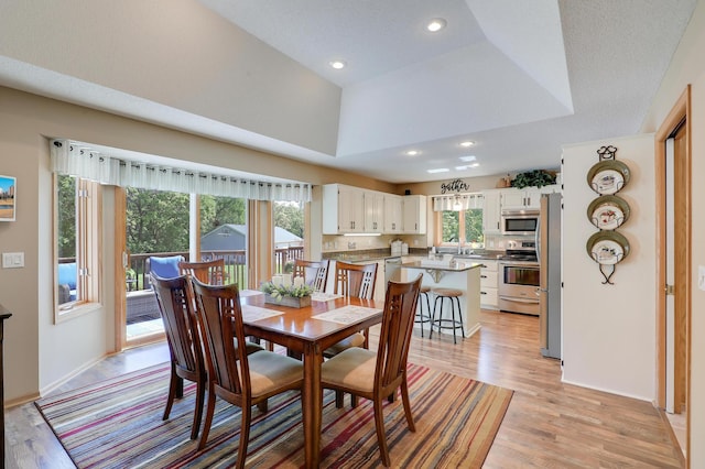 2301 170th Ln NW, Andover, MN 55304 - dining area featuring plenty of natural light, light wood-type flooring, recessed lighting, a raised ceiling, and baseboards