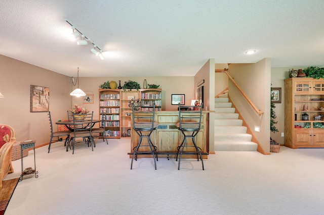 2301 170th Ln NW, Andover, MN 55304 - carpeted dining room with stairway, a textured ceiling, and track lighting