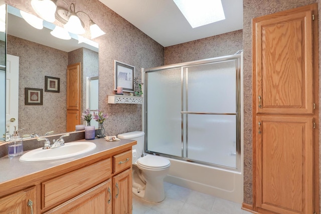 2301 170th Ln NW, Andover, MN 55304 - full bath featuring a skylight, wallpapered walls, vanity, toilet, and tile patterned flooring