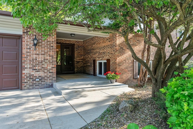 674 Mound Ave, Shoreview, MN 55126 - doorway to property with brick siding and a garage