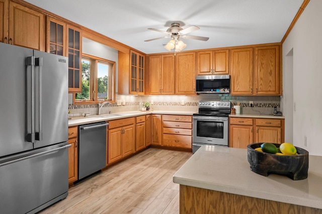 674 Mound Ave, Shoreview, MN 55126 - kitchen with appliances with stainless steel finishes, light countertops, light wood-style flooring, tasteful backsplash, and a ceiling fan