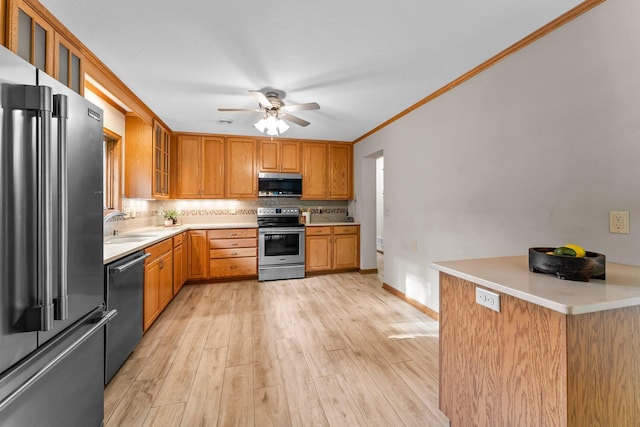 674 Mound Ave, Shoreview, MN 55126 - kitchen with appliances with stainless steel finishes, backsplash, ceiling fan, light wood-style flooring, and light countertops