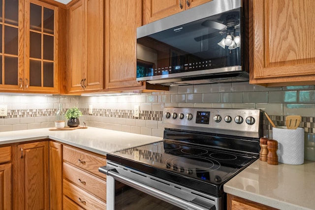 674 Mound Ave, Shoreview, MN 55126 - kitchen featuring appliances with stainless steel finishes, ceiling fan, backsplash, and light countertops
