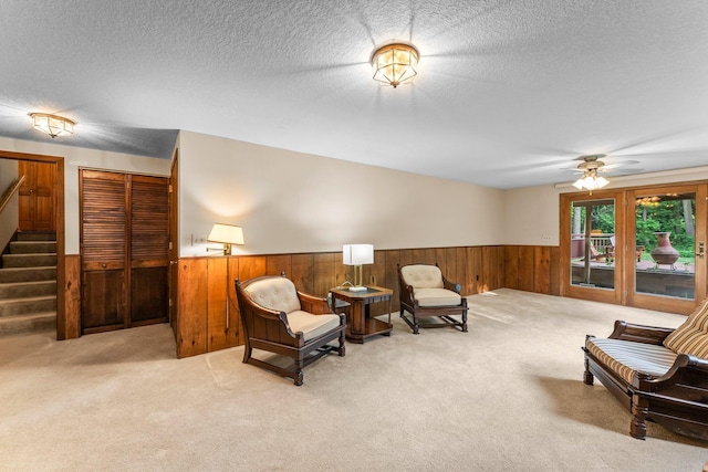 674 Mound Ave, Shoreview, MN 55126 - sitting room featuring a wainscoted wall, wood walls, carpet floors, stairway, and a ceiling fan