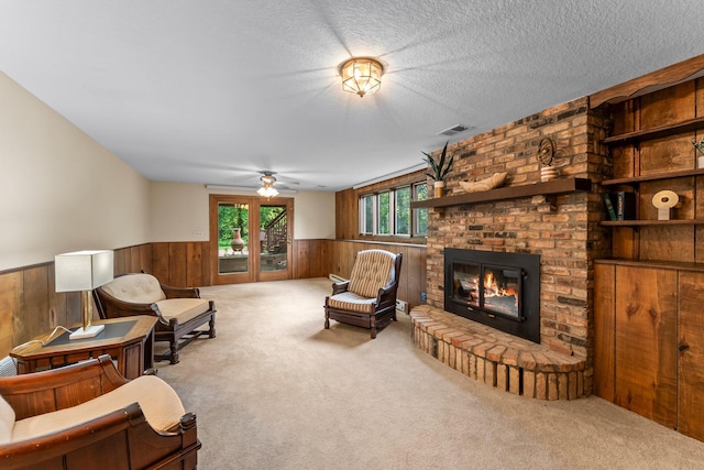 674 Mound Ave, Shoreview, MN 55126 - living room with a wainscoted wall, wooden walls, ceiling fan, carpet flooring, and a brick fireplace