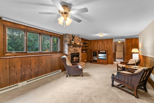 674 Mound Ave, Shoreview, MN 55126 - carpeted living room with wooden walls, a baseboard radiator, a ceiling fan, and a fireplace