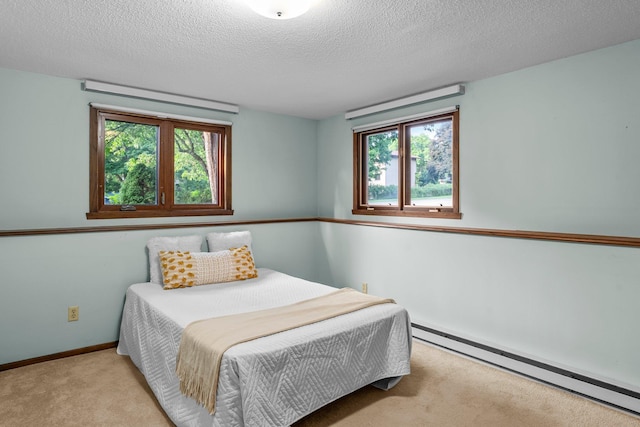 674 Mound Ave, Shoreview, MN 55126 - bedroom with a baseboard heating unit, multiple windows, light colored carpet, and a textured ceiling