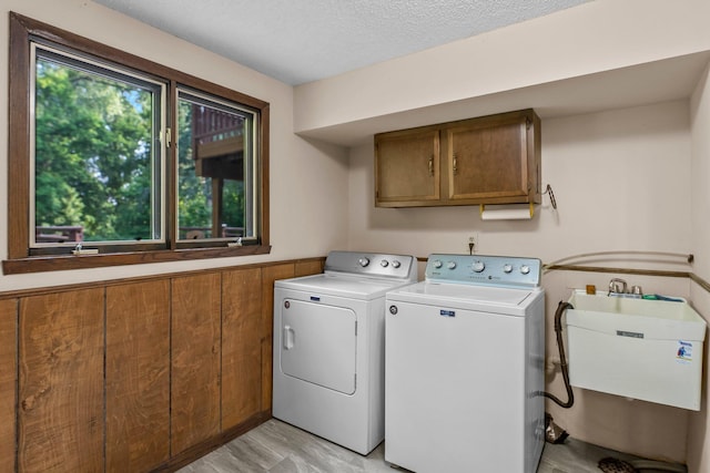 674 Mound Ave, Shoreview, MN 55126 - laundry room with cabinet space, washer and dryer, and a textured ceiling