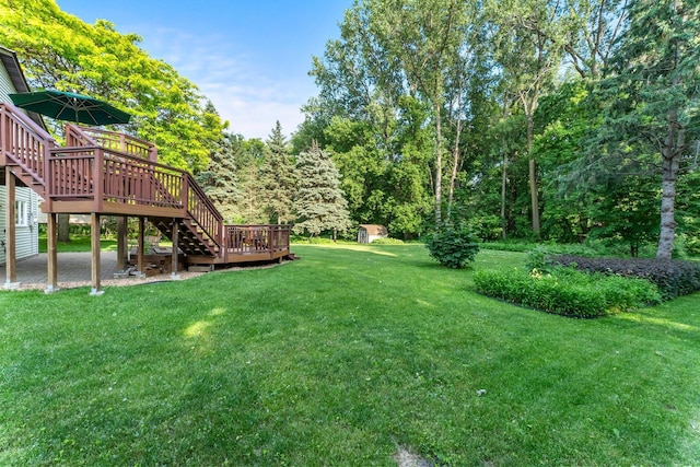 674 Mound Ave, Shoreview, MN 55126 - view of grassy yard featuring a wooden deck, stairway, and a storage shed