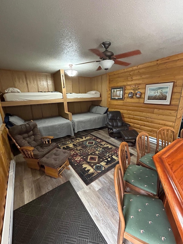 975 175th Ave SE, Kerkhoven, MN 56252 - bedroom featuring wood finished floors, rustic walls, and a textured ceiling
