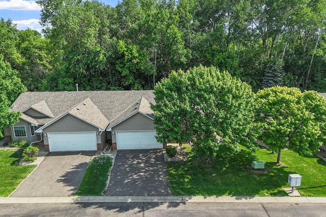 940 105th Ave NW, Coon Rapids, MN 55433 - view of front of property featuring asphalt driveway, a garage, brick siding, and roof with shingles