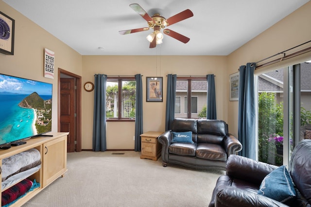 145 Bluebird Ln, Clearwater, MN 55320 - living area with light colored carpet, a ceiling fan, and baseboards